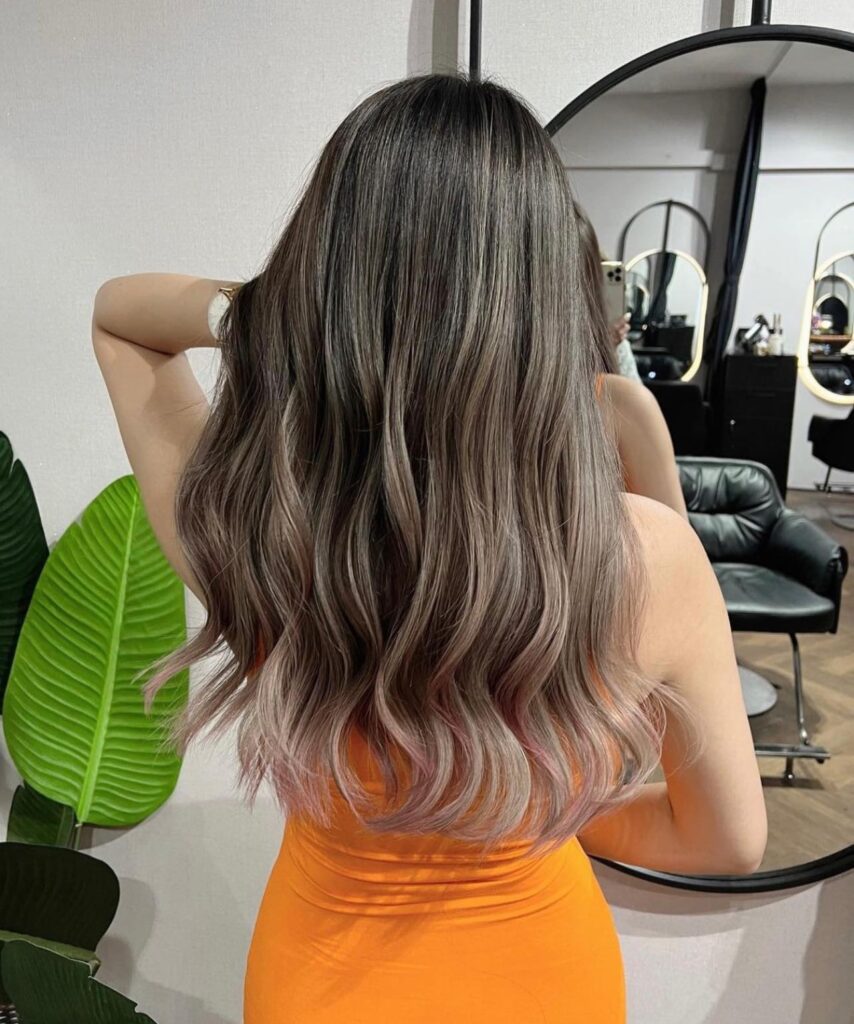 Women’s hair salon Tampines showing smooth long layered hairstyle after professional treatment